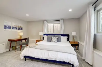 a bedroom with a bed and a desk and a window at 3 Min Walk To Olde Town! Hot Tub, Fire Pit, Games! in Arvada