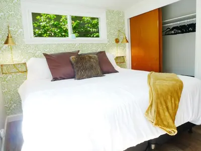 a bedroom with a white bed with pillows and a window at Private Studio - King Bed - Wifi in Arvada