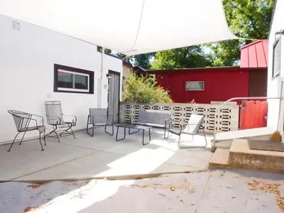 a patio with chairs and a table and a fence at Private Studio - King Bed - Wifi in Arvada