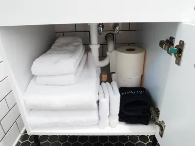 a bunch of towels are stacked on a shelf in a bathroom at Private Studio - King Bed - Wifi in Arvada