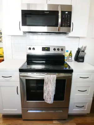 a kitchen with a stainless steel stove and a microwave at Private Studio - King Bed - Wifi in Arvada