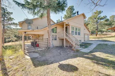 a house with a tree in front of it at 17 Mi to Town Peaceful Golden Cabin! in Golden
