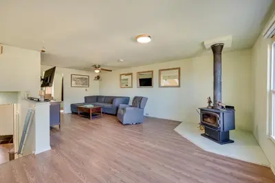a living room with a couch and a stove at 17 Mi to Town Peaceful Golden Cabin! in Golden