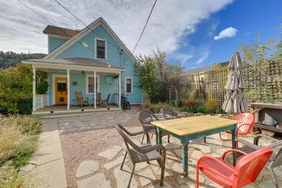 a blue house with a table and chairs at Home in Downtown Idaho Springs 2022-01 in Idaho Springs