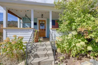 a house with a porch with a flag on it at Home in Downtown Idaho Springs 2022-01 in Idaho Springs