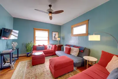 a living room with blue walls and red furniture at Home in Downtown Idaho Springs 2022-01 in Idaho Springs