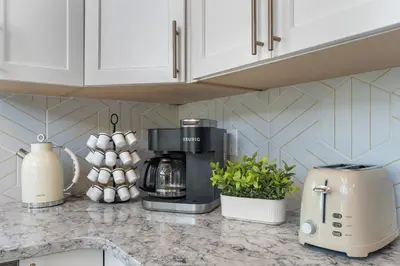 a kitchen counter with a coffee maker and a toaster at Cozy A-Frame Retreat - Hot Tub, Forest Views in Black Hawk
