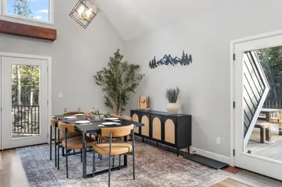 a dining room with a table and chairs at Cozy A-Frame Retreat - Hot Tub, Forest Views in Black Hawk