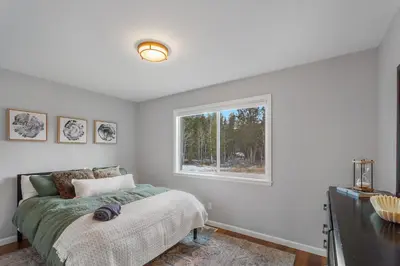 a bedroom with a bed and a window at Cozy A-Frame Retreat - Hot Tub, Forest Views in Black Hawk