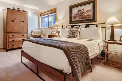 a bedroom with a large bed and a dresser at Buffalo Ridge G214 in Silverthorne