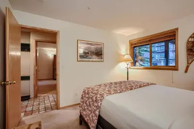 a bedroom with a bed and a window at Buffalo Ridge G214 in Silverthorne