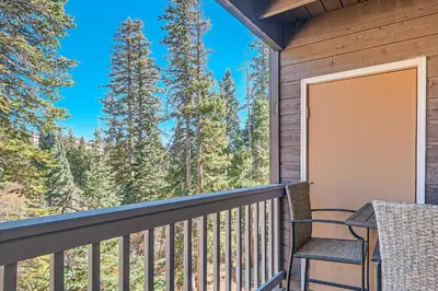 a balcony with chairs and a view of the woods at Buffalo Ridge G214 in Silverthorne