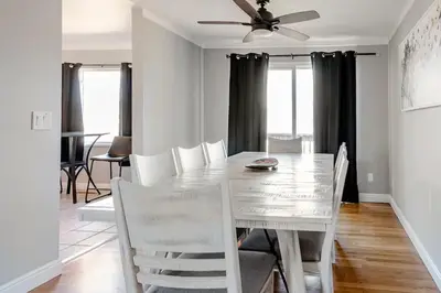 a dining room table with white chairs and a ceiling fan at 4 Bedrooms and 5 Beds with Game Room Only 5 min Drive to College and Perfect for Family's in Boulder