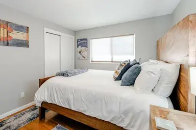 a bedroom with a large white bed and a window at 4 Bedrooms and 5 Beds with Game Room Only 5 min Drive to College and Perfect for Family's in Boulder