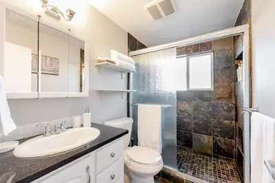a bathroom with a sink and a toilet and a shower at 4 Bedrooms and 5 Beds with Game Room Only 5 min Drive to College and Perfect for Family's in Boulder