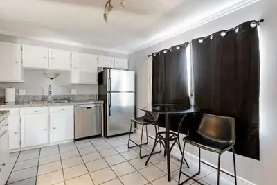 a kitchen with a table and chairs and a refrigerator at 4 Bedrooms and 5 Beds with Game Room Only 5 min Drive to College and Perfect for Family's in Boulder