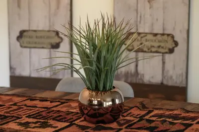 a vase with grass in it sitting on a table at Ridgeview at Granby Ranch townhouse in Granby