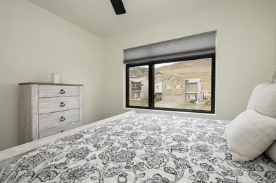 a bedroom with a bed and a large window at Ridgeview at Granby Ranch townhouse in Granby