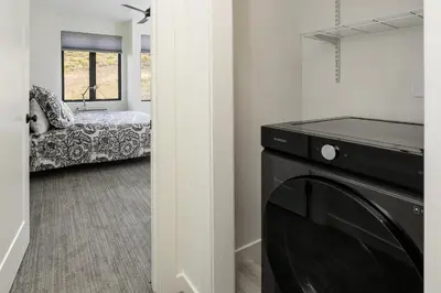 a living room with a black tv and a couch at Ridgeview at Granby Ranch townhouse in Granby