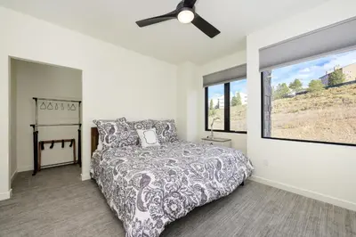 a bedroom with a bed and a ceiling fan at Ridgeview at Granby Ranch townhouse in Granby