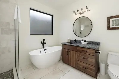 a bathroom with a tub and a sink and a mirror at Ridgeview at Granby Ranch townhouse in Granby