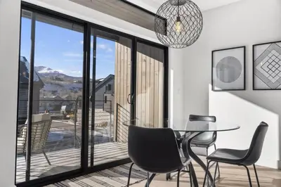 a dining room with a glass table and chairs at 2BDR New Build Minutes to Dillon Reservoir in Silverthorne