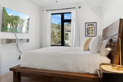 a white bedroom with a large bed and a window at 2BDR New Build Minutes to Dillon Reservoir in Silverthorne