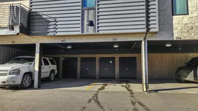 a parking garage with a white car parked in it at 2BDR New Build Minutes to Dillon Reservoir in Silverthorne