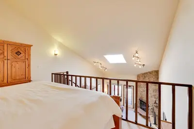 a bedroom with a large bed and a balcony at Private Balcony and Mtn Views Granby Studio! in Granby