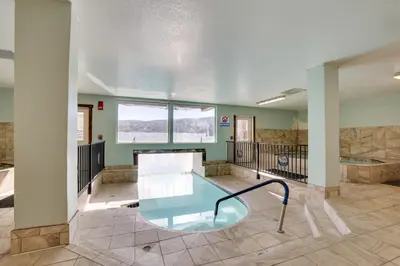 a room with a glass table in the middle at Private Balcony and Mtn Views Granby Studio! in Granby