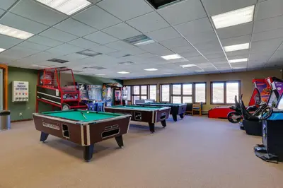 a gaming room with pool tables and fire trucks at Private Balcony and Mtn Views Granby Studio! in Granby