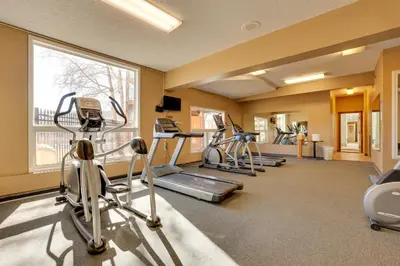 a gym with several treadmills and elliptical machines at Private Balcony and Mtn Views Granby Studio! in Granby