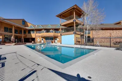 a swimming pool in the courtyard of a building at Private Balcony and Mtn Views Granby Studio! in Granby