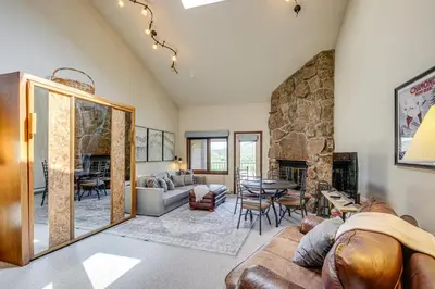 a living room with a couch and a fireplace at Private Balcony and Mtn Views Granby Studio! in Granby