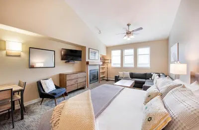 a living room with a bed and a tv at Premium Unit 4650- Fraser Crossing Founders Pointe condo in Winter Park