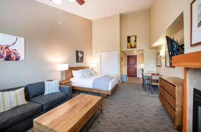 a hotel room with a bed and a couch at Premium Unit 4650- Fraser Crossing Founders Pointe condo in Winter Park
