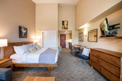 a hotel room with a bed and a dining room at Premium Unit 4650- Fraser Crossing Founders Pointe condo in Winter Park