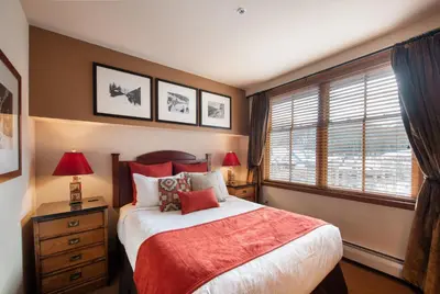 a bedroom with a large bed and a window at Select Unit 1520- 3 Bedroom- Zephyr Mountain Lodge condo in Winter Park