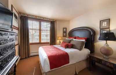 a bedroom with a large bed and a television at Select Unit 1520- 3 Bedroom- Zephyr Mountain Lodge condo in Winter Park