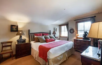 a bedroom with a large bed with red pillows at Select Unit 1520- 3 Bedroom- Zephyr Mountain Lodge condo in Winter Park