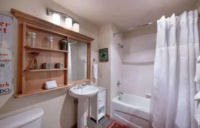 a bathroom with a sink and a toilet and a tub at Select Unit 1520- 3 Bedroom- Zephyr Mountain Lodge condo in Winter Park