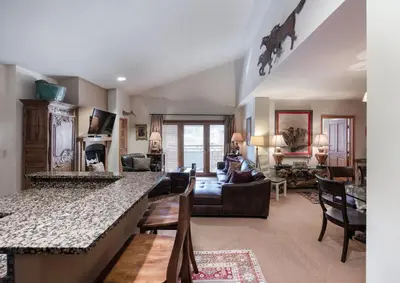 a living room with a kitchen and a living room with a couch at Select Unit 1520- 3 Bedroom- Zephyr Mountain Lodge condo in Winter Park