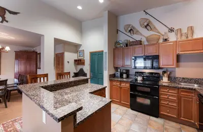 a kitchen with wooden cabinets and a counter top at Select Unit 1520- 3 Bedroom- Zephyr Mountain Lodge condo in Winter Park