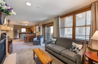a living room with a couch and a kitchen at Premium Unit 1327 - 1 Bedroom - Zephyr Mountain condo in Winter Park