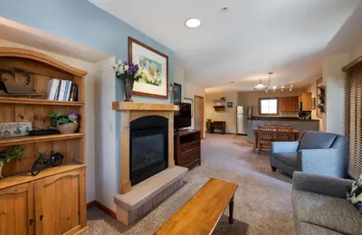 a living room with a fireplace and a couch at Premium Unit 1327 - 1 Bedroom - Zephyr Mountain condo in Winter Park