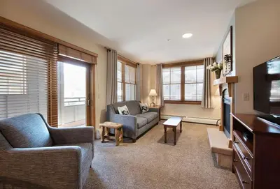 a living room with a couch and a tv at Premium Unit 1327 - 1 Bedroom - Zephyr Mountain condo in Winter Park