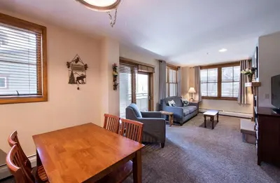 a living room with a table and a dining room at Premium Unit 1327 - 1 Bedroom - Zephyr Mountain condo in Winter Park