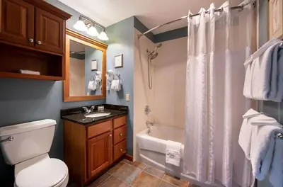 a bathroom with a toilet and a shower and a sink at Premium Unit 1327 - 1 Bedroom - Zephyr Mountain condo in Winter Park