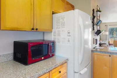 a microwave sitting on a counter next to a refrigerator at Salt Lick Sanctuary in Silverthorne