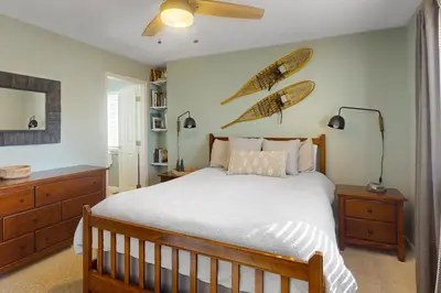 a bedroom with a bed and two surfboards on the wall at Salt Lick Sanctuary in Silverthorne